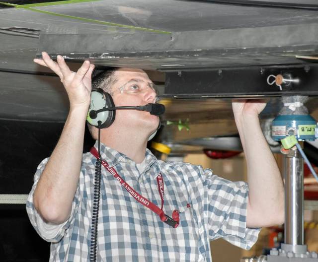 Armstrong lead engineering tech Aaron Rumsey adjusted a rubber contact pad between the wing of NASA’s G-III and a load cell mou
