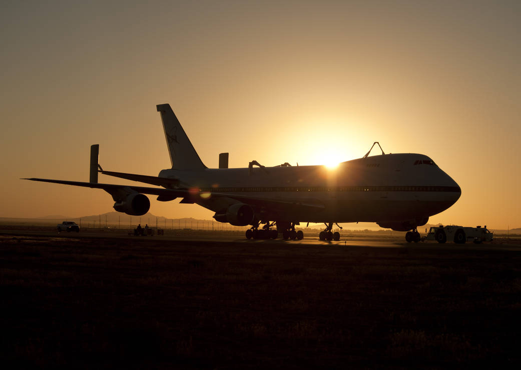 Silhouetted at sunrise, NASA’s retired space shuttle carrier aircraft No. 911 is prepared for its final journey