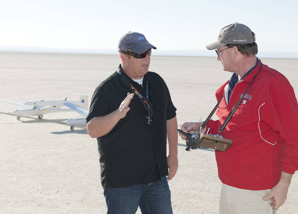 Robert “Red”Jensen and Gerald Budd discuss flight procedures prior to takeoff..