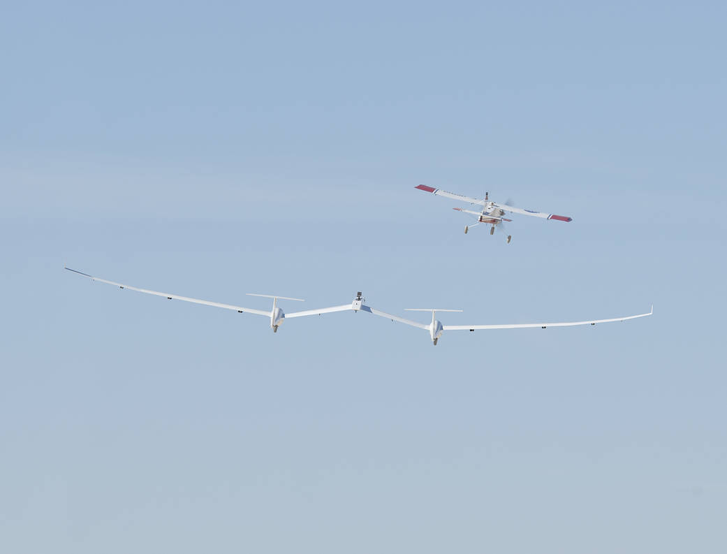 One of NASA Armstrong’s DROID small unmanned research aircraft tows the twin-fuselage towed glider.