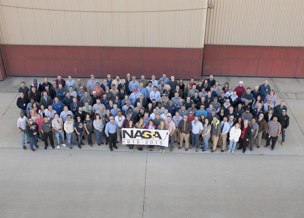 Current employees pose for a group photo in front of Armstrong's science aircraft building 703 in Palmdale, CA.
