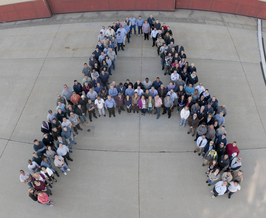 Forming an "A" for Armstrong, employees who work in building 703 posed to recognize the 100-year anniversary of NACA.