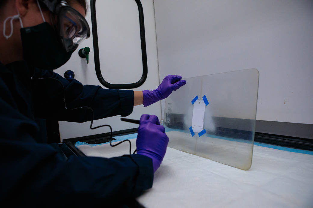 Inside a laboratory at NASA’s Kennedy Space Center in Florida, research scientist Sarah Snyder works with a selective coating.