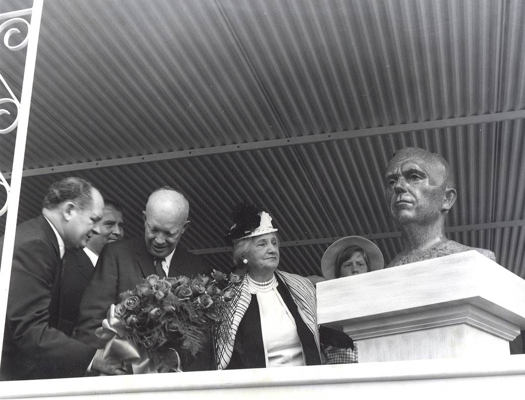 President Dwight D. Eisenhower and Mrs. George C. Marshall unveil the bronze bust of General George C. Marshall.