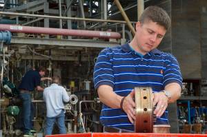 Propulsion systems engineer Greg Barnett prepares a rocket injector for a hot fire test at NASA's Marshall Space Flight Center i