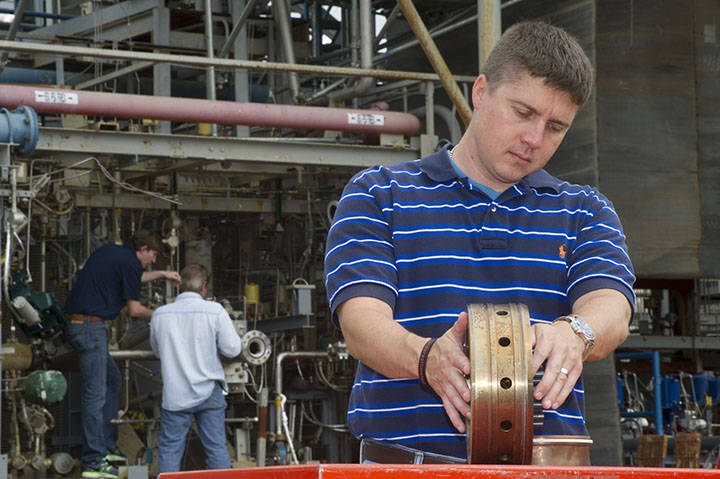 Propulsion systems engineer Greg Barnett prepares a rocket injector for a hot fire test at NASA's Marshall Space Flight Center i