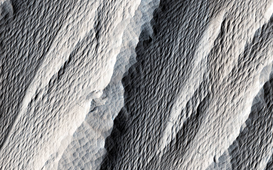 Windswept elongated hills in closeup on Mars surface