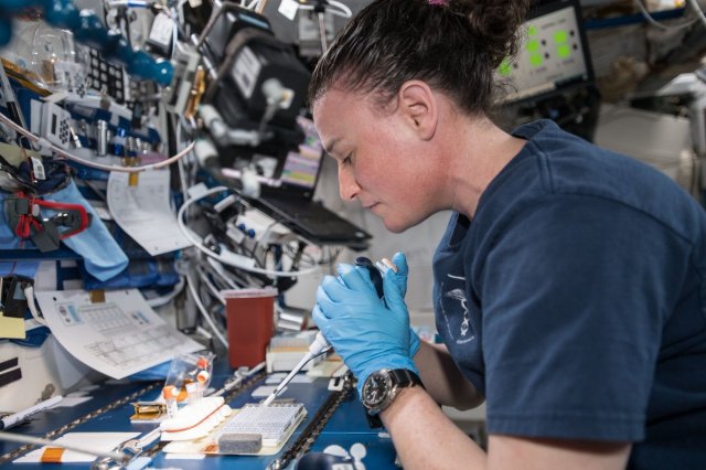 astronaut mixes protein crystal samples