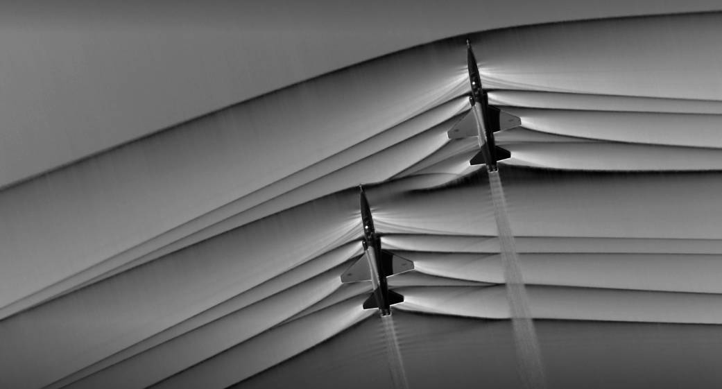 Schlieren photography image of two T-38 aircraft creating shockwaves.