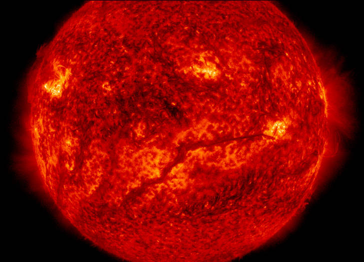 A dark, solar filament hovered above the Sun's surface, extending across more than half the Sun. 