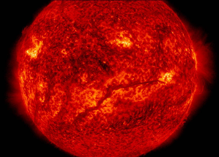 A dark, solar filament hovered above the Sun's surface, extending across more than half the Sun.