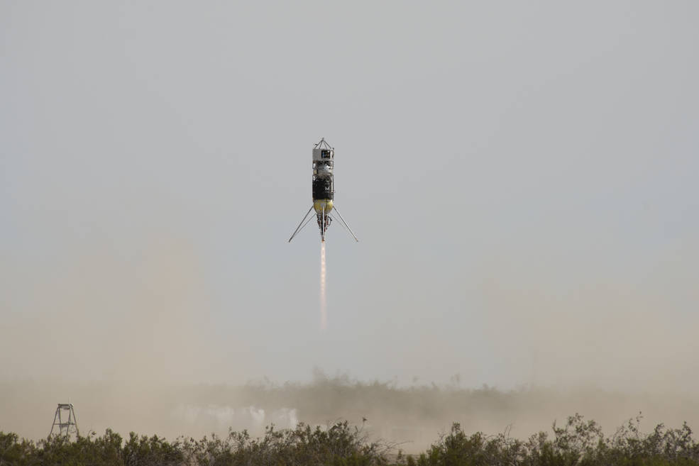 Rocket launching with a blue/gray sky in the background.