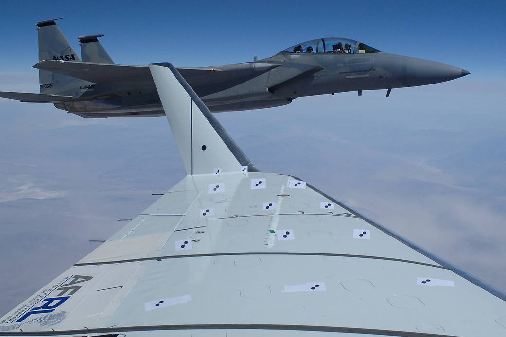F-15D plane flying chase, photographed from the window of plane carrying wing flap experiment