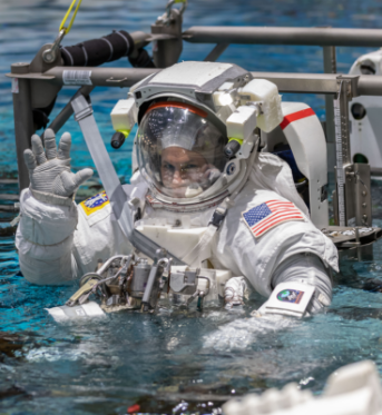 Boeing Commercial Crew Program astronaut Josh Cassada waves before entering the pool at the Neutral Buoyancy Laboratory for ISS EVA training in preparation for future spacewalks while onboard the International Space Station at the Johnson Space Center April 12, 2019 in Houston, Texas.