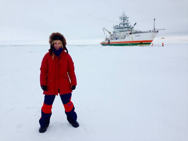 Assistant Research Scientist Rachel Tilling standing on an icy landscape. 