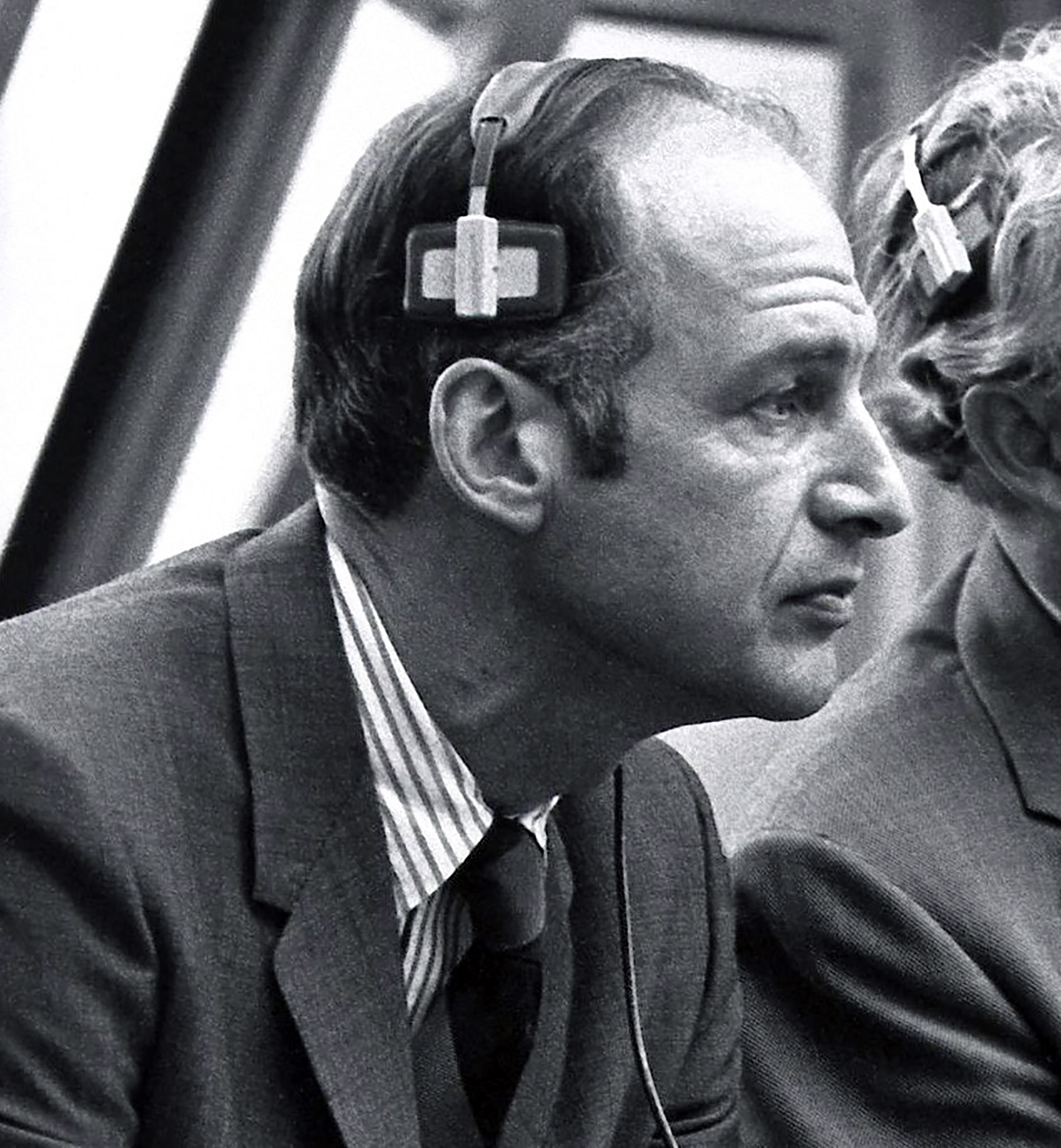 George Low in control room with headset.