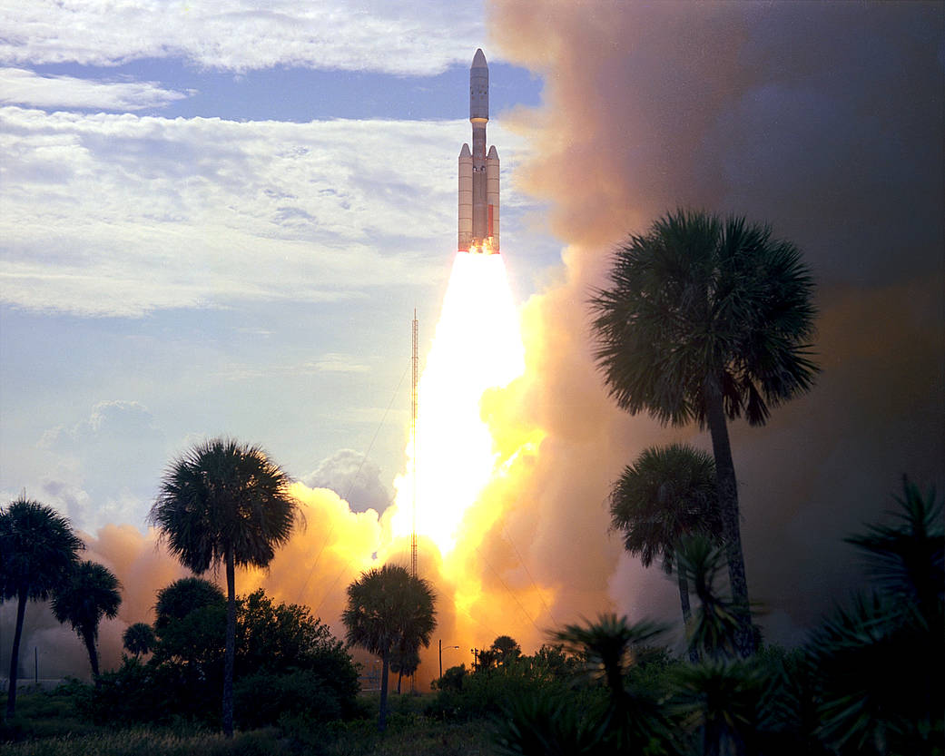Launch of rocket carrying Viking 1 spacecraft with palm trees in foreground