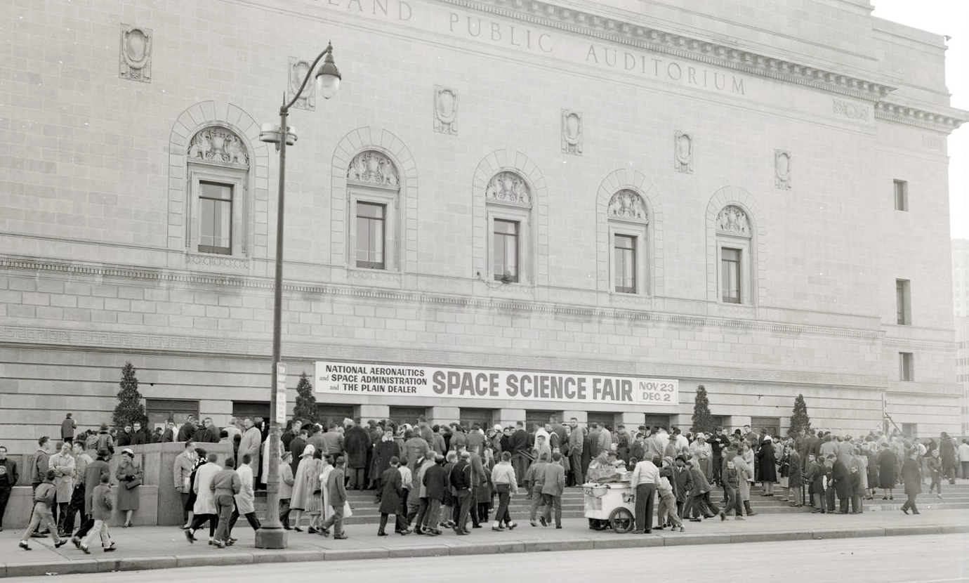 Crowd of people outside building.