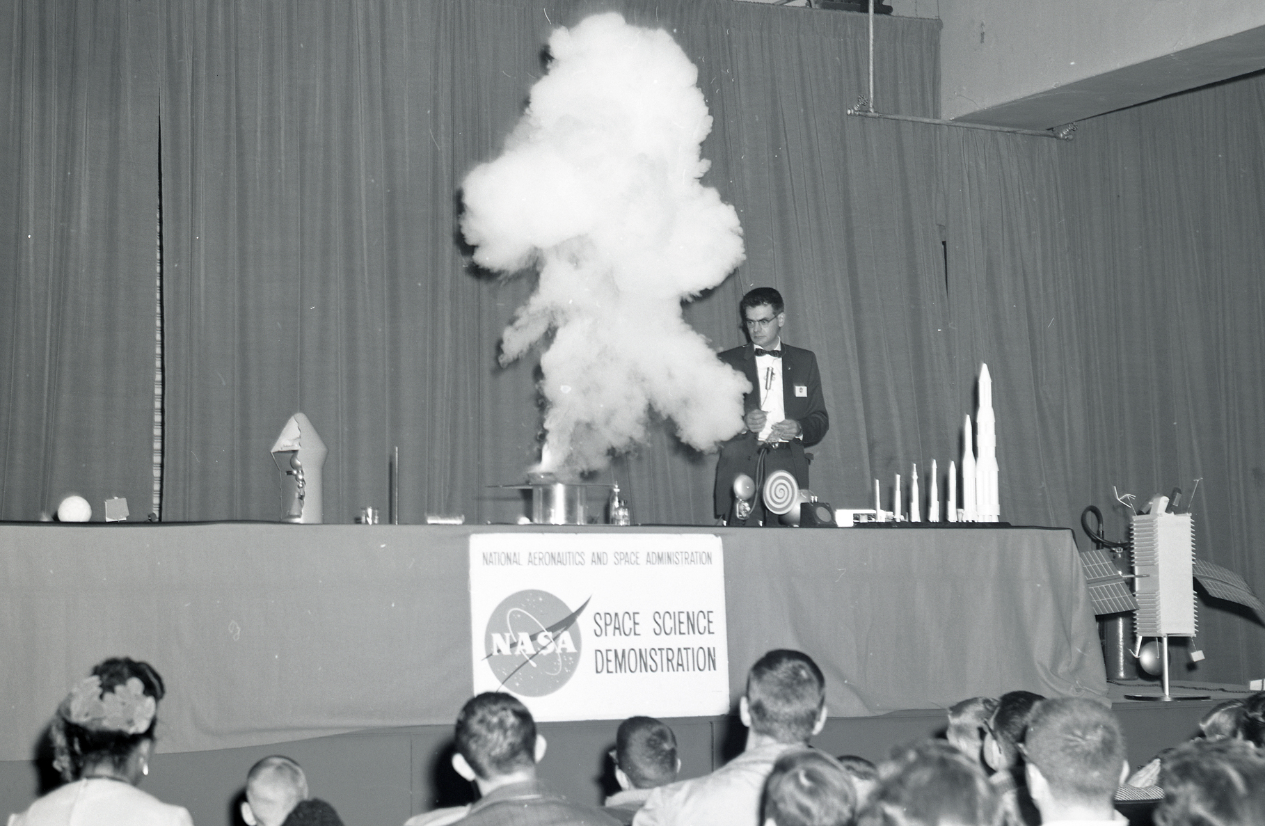 Man giving scientific demonstration for audience.