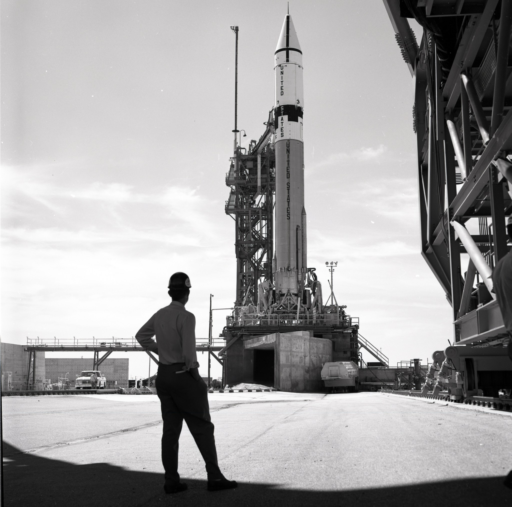 Man looking at rocket on launch pad.