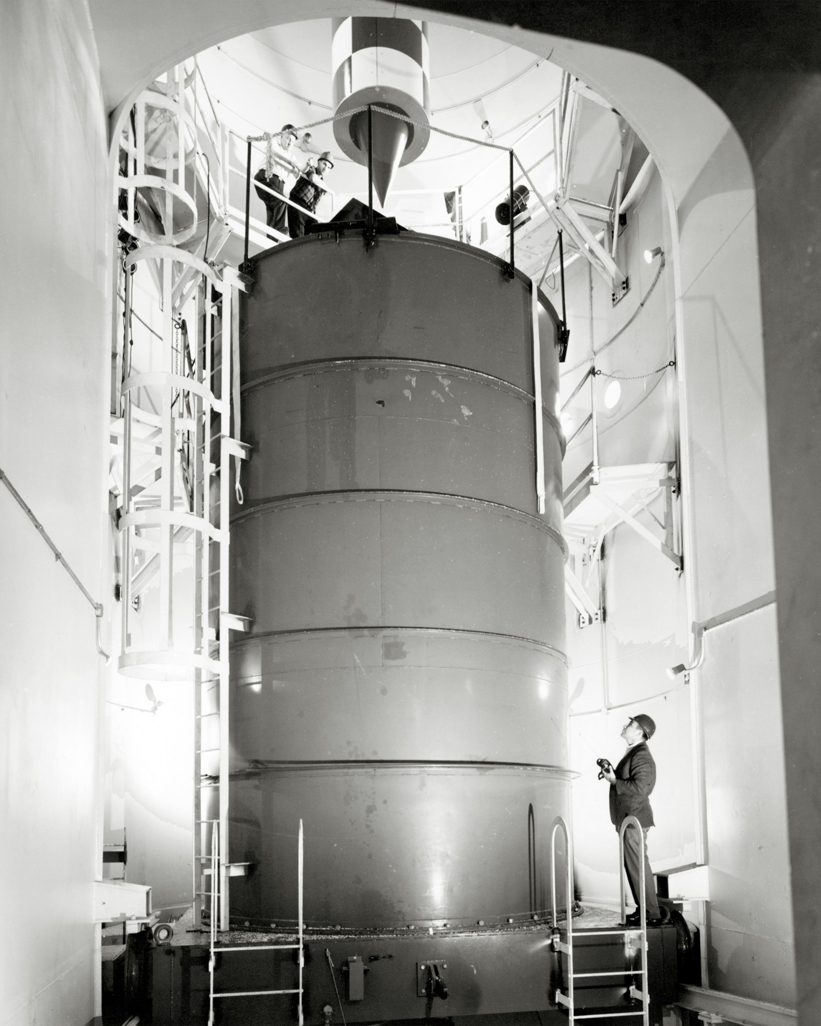 Men viewing deceleration cart in Zero Gravity Facility.