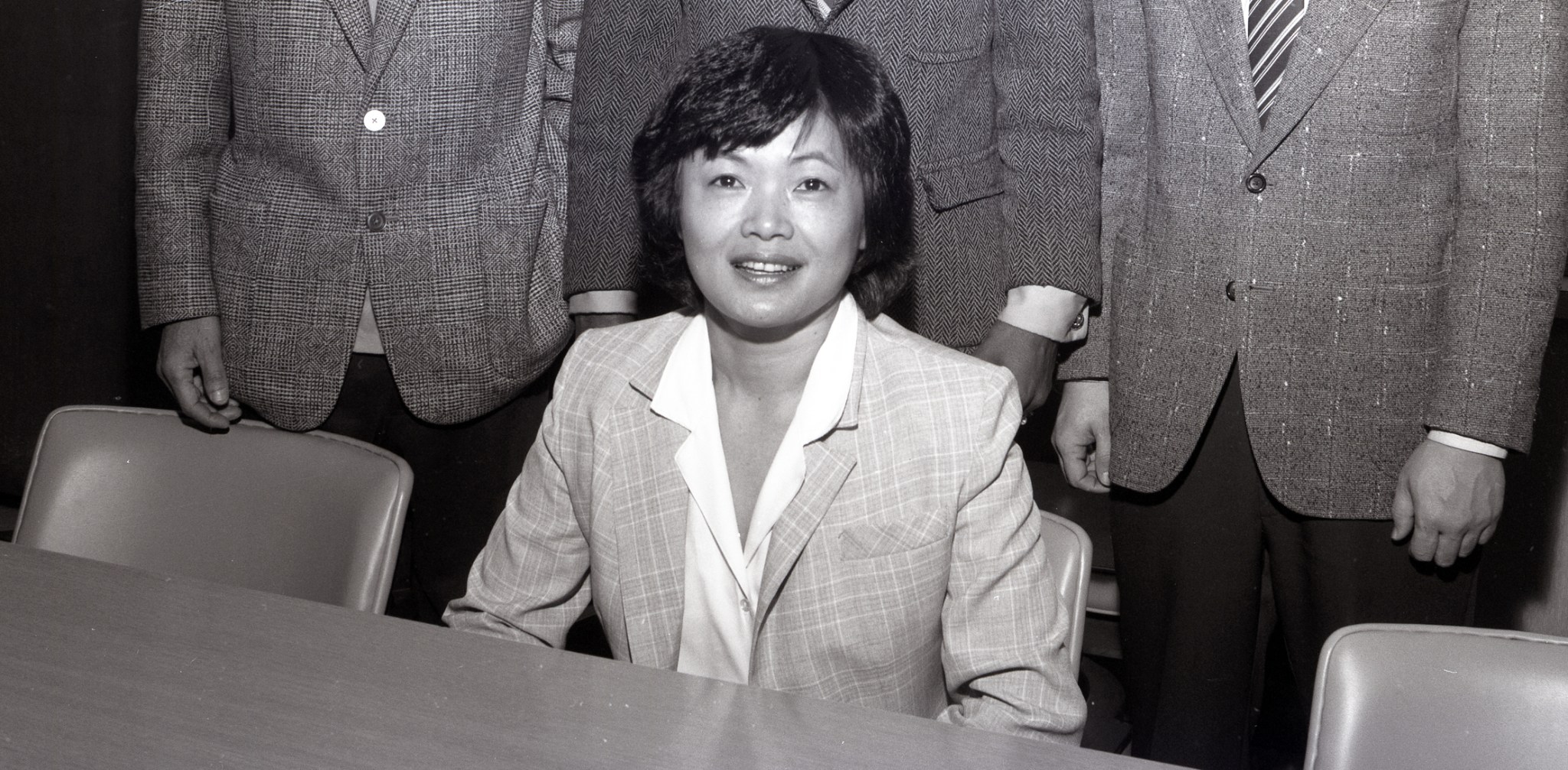 Woman sitting at table.