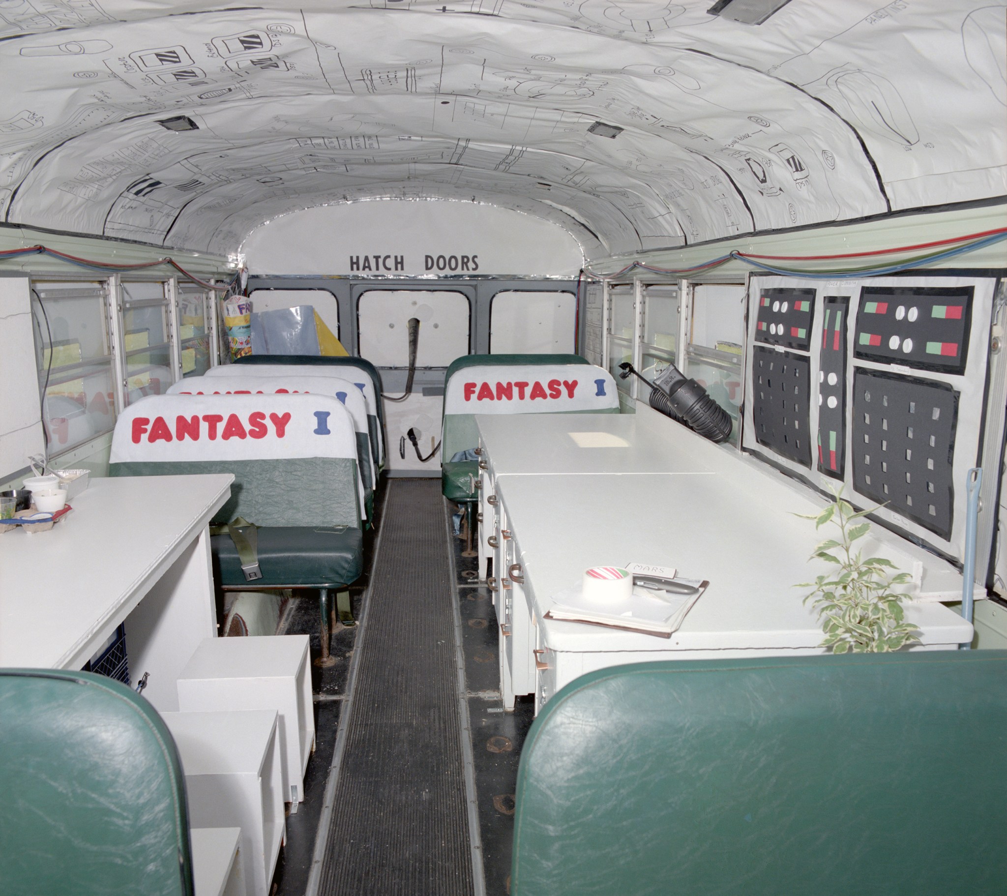 Interior of bus decorated as space shuttle.