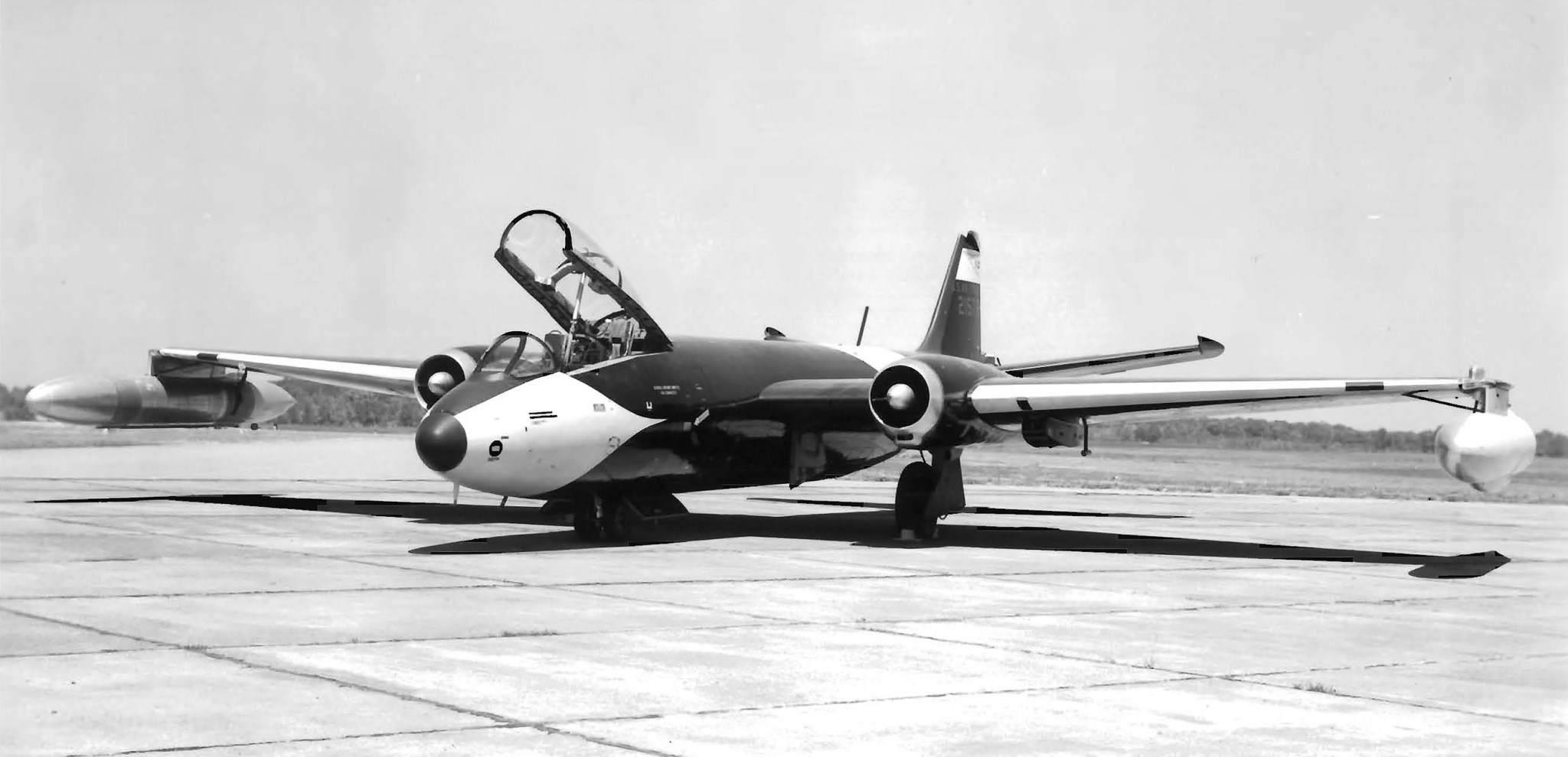 B-57 bomber on tarmac with cockpit open.