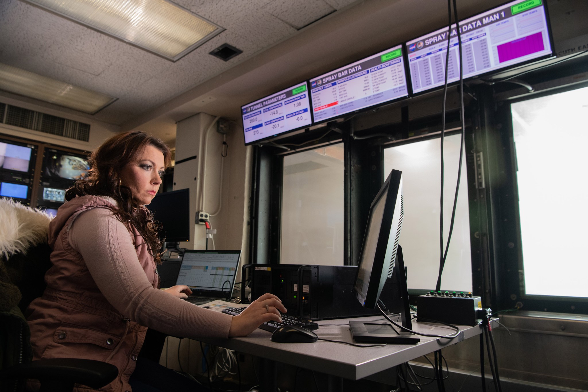 Engineer Emily Timko works at a computer station in the Icing Research Tunnel at Glenn Research Center.