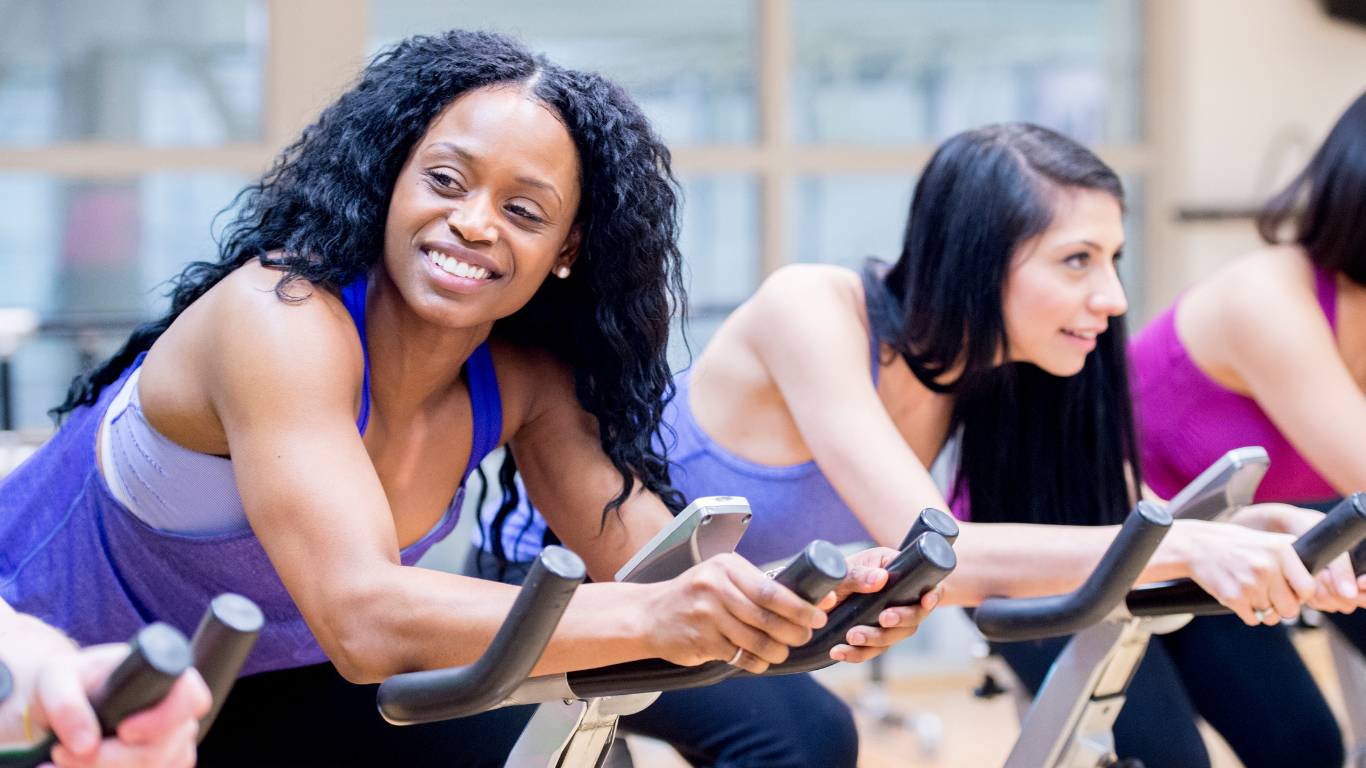 group of people on stationary bikes