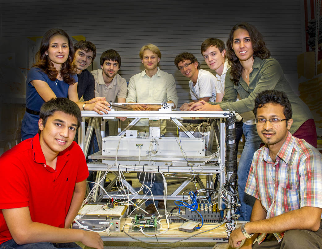 Goddard student interns pose with the BETTII instrument.