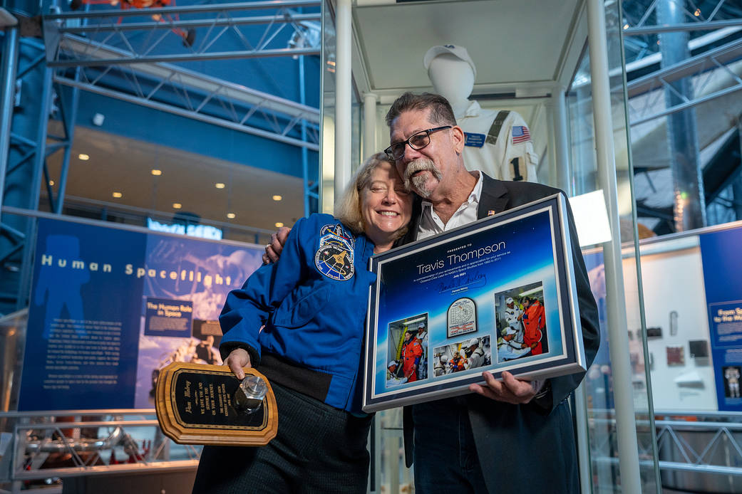 On July 9th, 2021, Travis Thompson, former Closeout Crew Lead who served for nearly 100 missions, and Deputy Administrator Pamela Melroy, view his uniform at its exhibit in the National Air and Space Museum, Steven F. Udvar-Hazy Center in Chantilly, VA.
