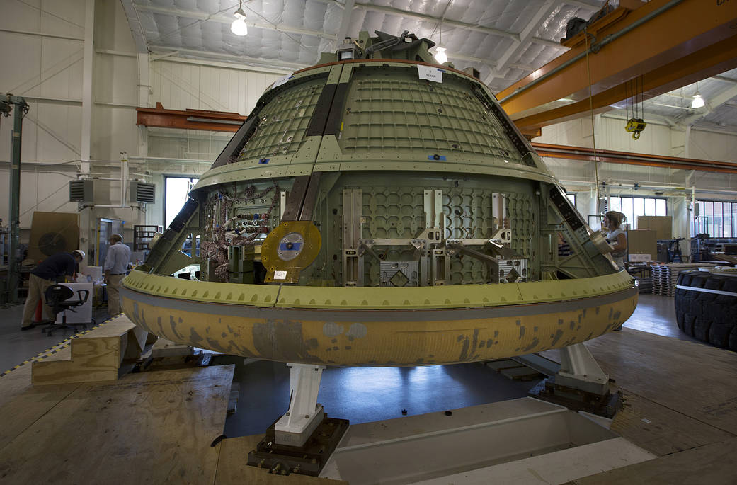 NASA engineers couple an Orion crew module mock-up with the heat shield from the Orion flight test for water landing tests next 