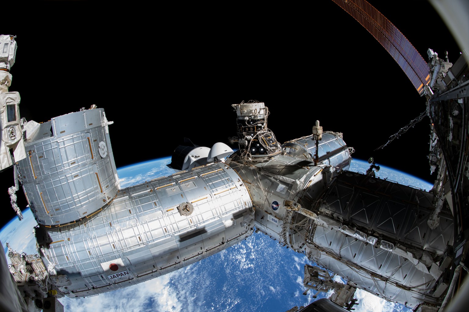 A portion of the International Space Station's U.S. segment is pictured from NASA spacewalker Thomas Marshburn's camera. From left, are the Kibo laboratory module; the Harmony module, to which the SpaceX Crew Dragon Endurance is docked, and the space-facing international docking adapter; the Columbus laboratory module; and the U.S. Destiny laboratory module.