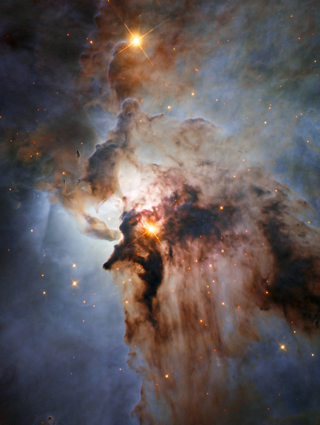 Bright nebula with dark clouds of gas extending from center