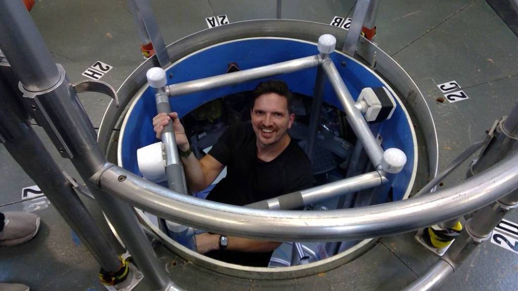 HERA crew member Christopher Roberts ascends a ladder inside a small habitat that NASA uses to simulate missions to Mars.