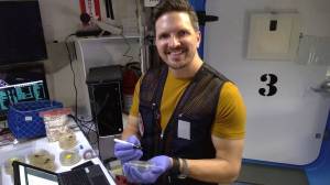 HERA crew member Christopher Roberts holds a petri dish for storing swabs of microbes from the habitat.