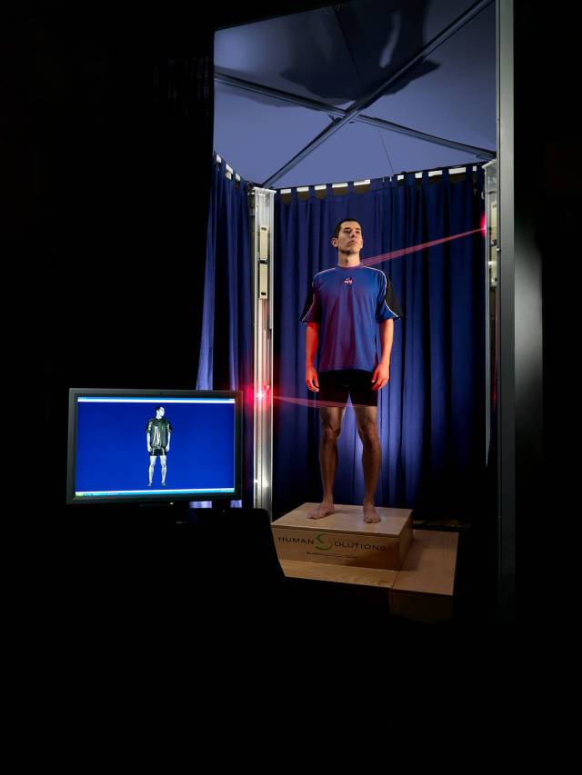 A test subject stands in the Whole-Body Laser Scanner 