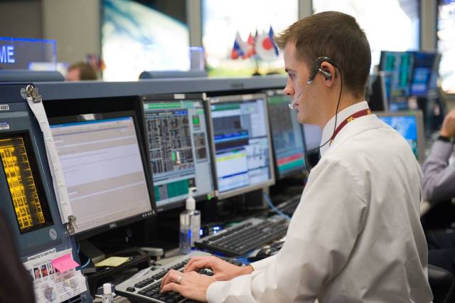 A biomedical engineer (BME) works console during a mission.