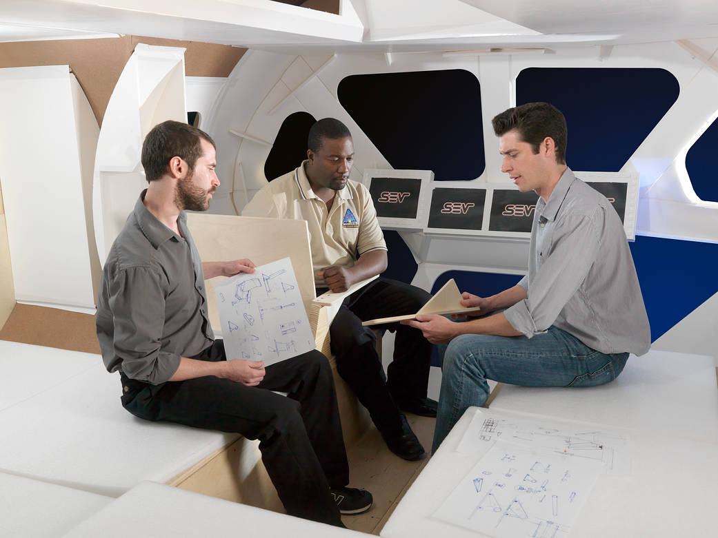 Human Factors Design Engineers inside the mockup of the Space Exploration Vehicle