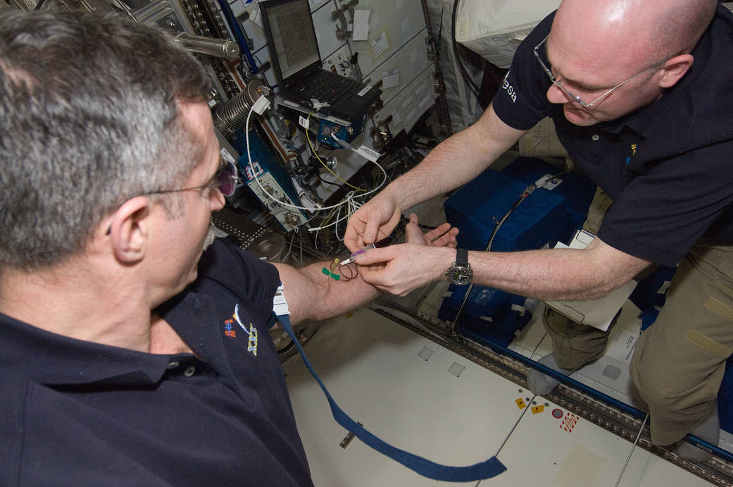 Crewmembers perform a blood draw