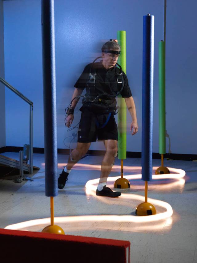 A test subject maneuvers an obstacle course which evaluates functional capability in the Neuroscience Laboratory.