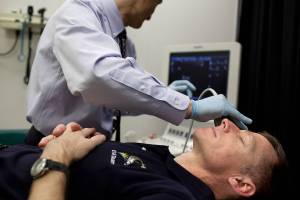 NASA astronaut Chris Ferguson has his eyes imaged using ultrasound