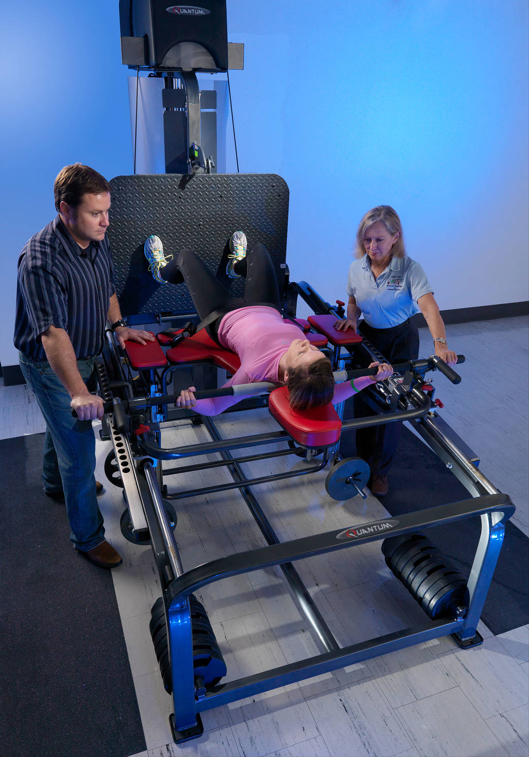 HRP trainers work with a test subject on specialized exercise equipment