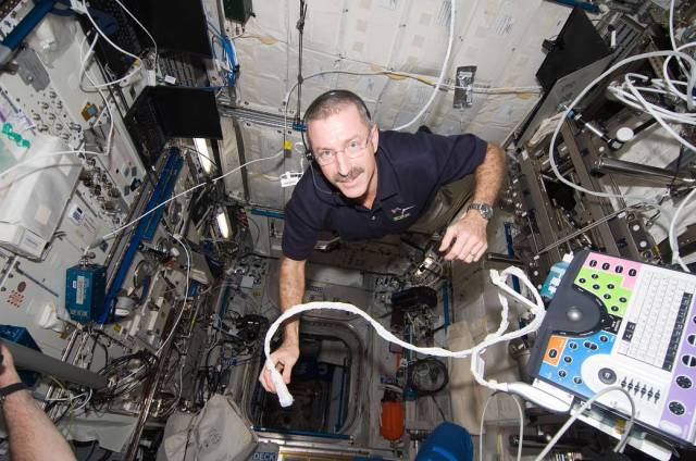 Crewmember using ultrasound on-orbit