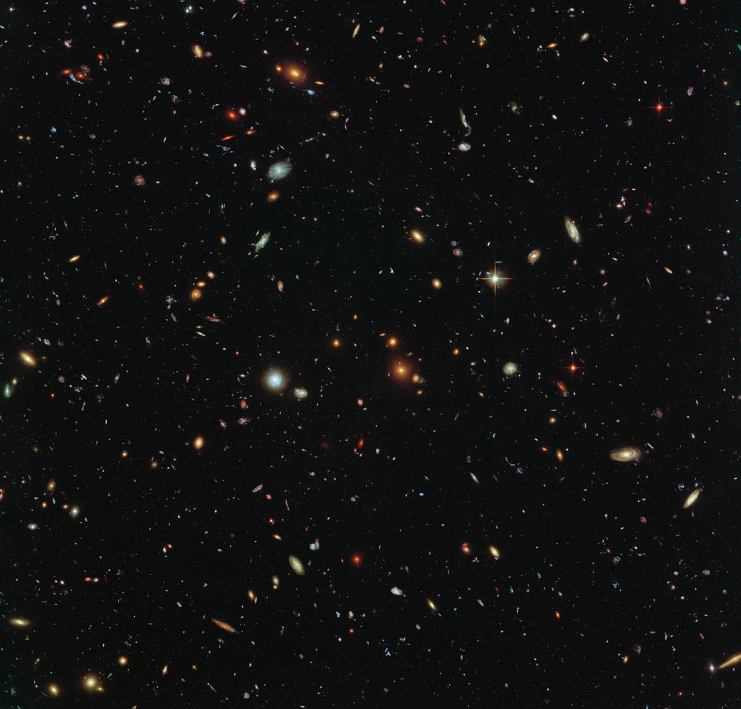 Thousands of colorful galaxies swimming in the inky blackness of space