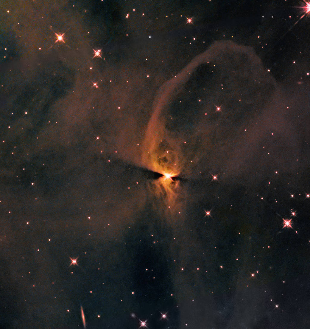 Against a backdrop of stars and distant galaxies, an orange glow of looping clouds emanates from a bright-white central star. Dark dust lanes extend from the right and left of the central star.