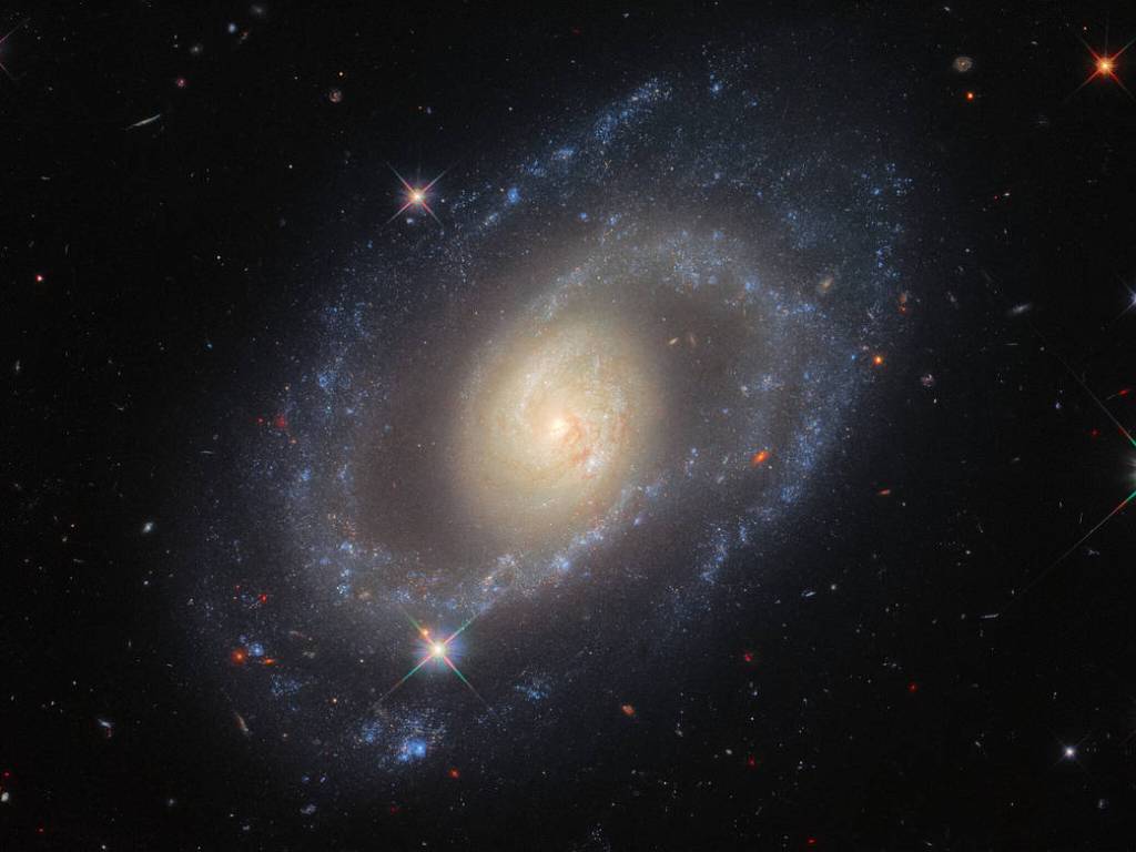 Hubble image of spiral galaxy Mrk 1337. Bright central bulge with two prominent spiral arms emerging from it. 
