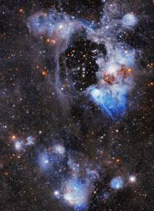 Upper 2/3 holds a bright white and blue gas and dust-cloud ring around a central void or bubble. Lower 1/3 holds blue and white "cotton ball" like clouds, several holding bright stars. Reddish-orange stars also dot the scene throughout.