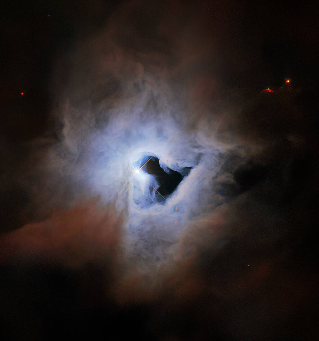 Bright blue-white cloud with a black keyhole-shaped void in the middle. Edge of the blue-white cloud transitions to brownish-rusty colored cloud.